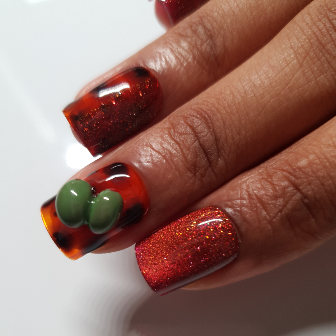 Red reflective cat-eye color, tortoise nail-art and 3d olives worn on square shaped press-on nails