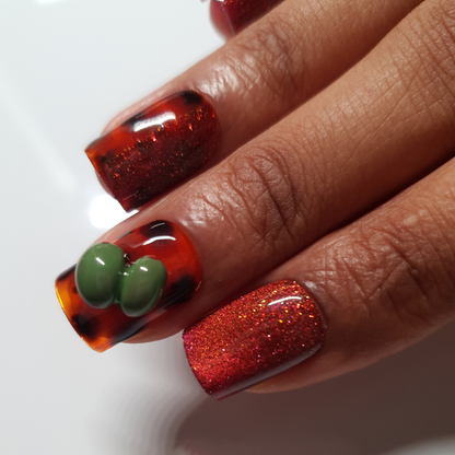Red reflective cat-eye color, tortoise nail-art and 3d olives worn on square shaped press-on nails